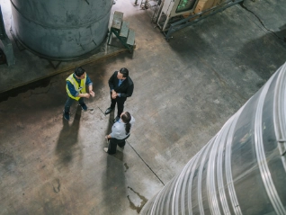Workers having a discussion in a large warehouse