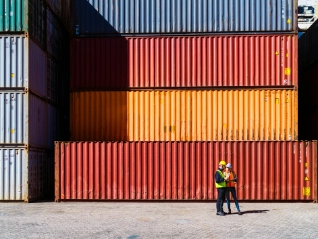 Two workers having a conversation about containers