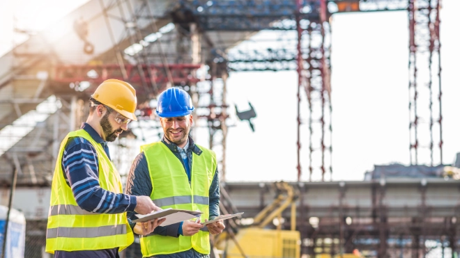 two construction workers conducting a survey