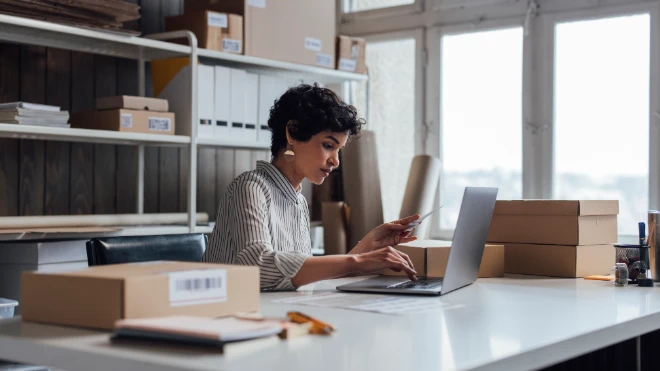 Mixed race woman in an office surrounded by boxes