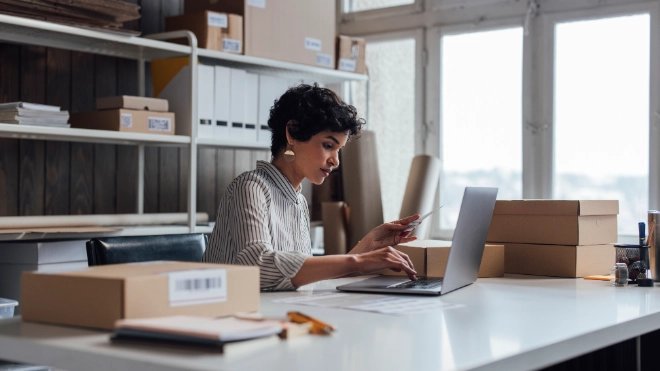 Woman in office surrounded by boxes