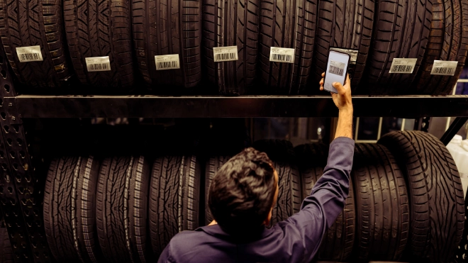 Automotive worker checking tyres