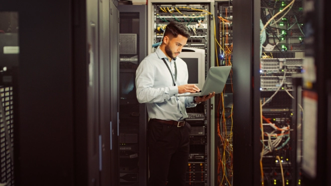 Young male worker in computer room