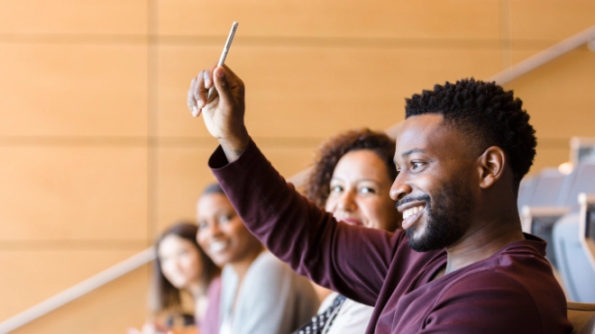 Man raising his hand to ask a question
