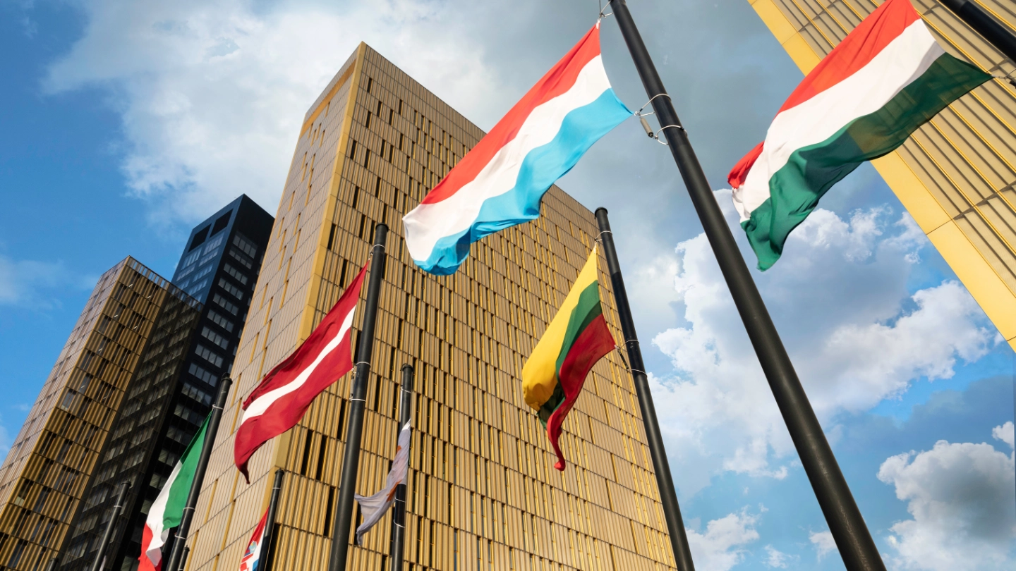 European Flags flapping in the wind, in front of European Union Court of Justice building in Luxembourg Kirchberg. Flags of Luxembourg, Hungary, Lithuania, Austria... image