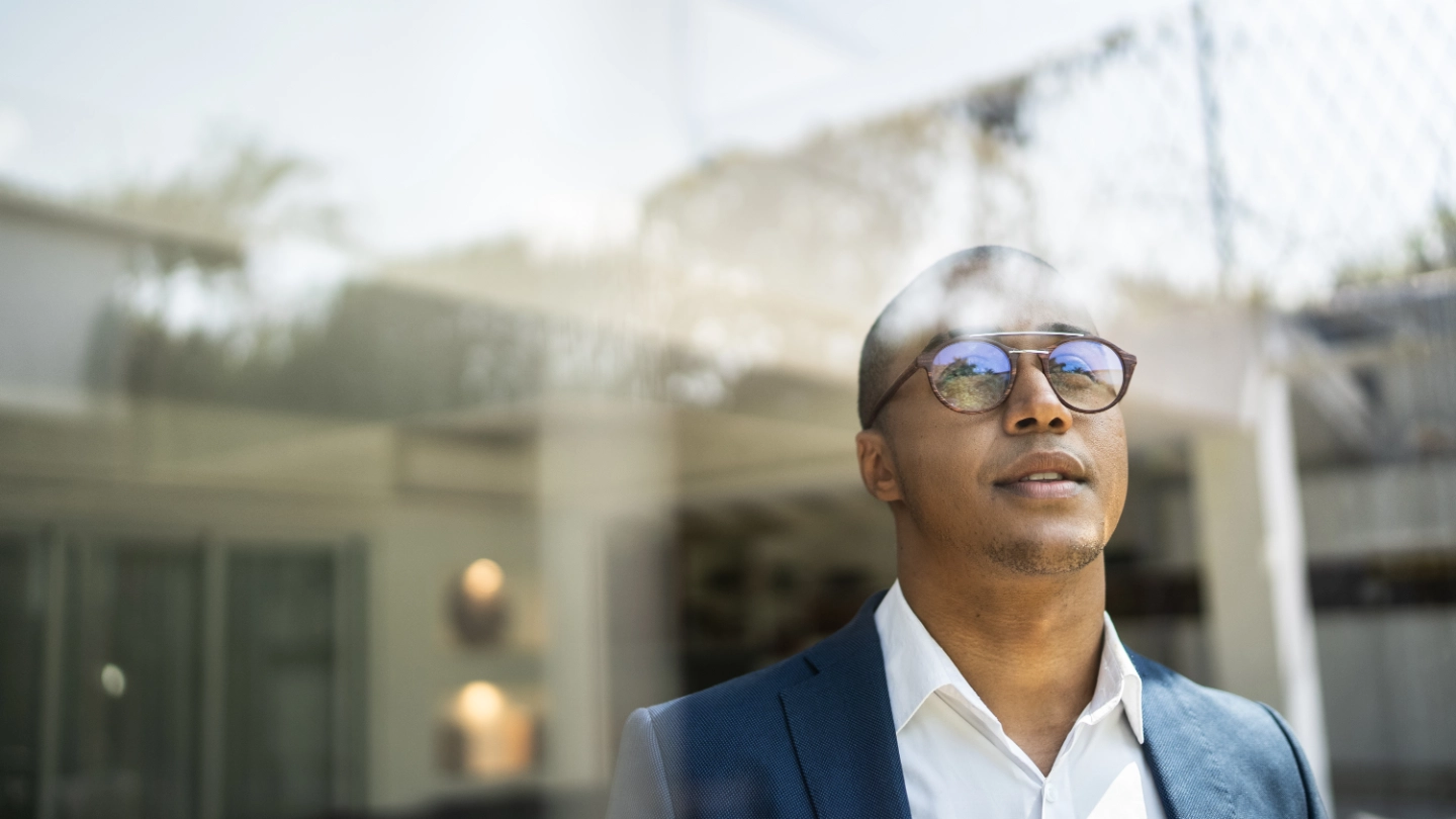 man looking out window image