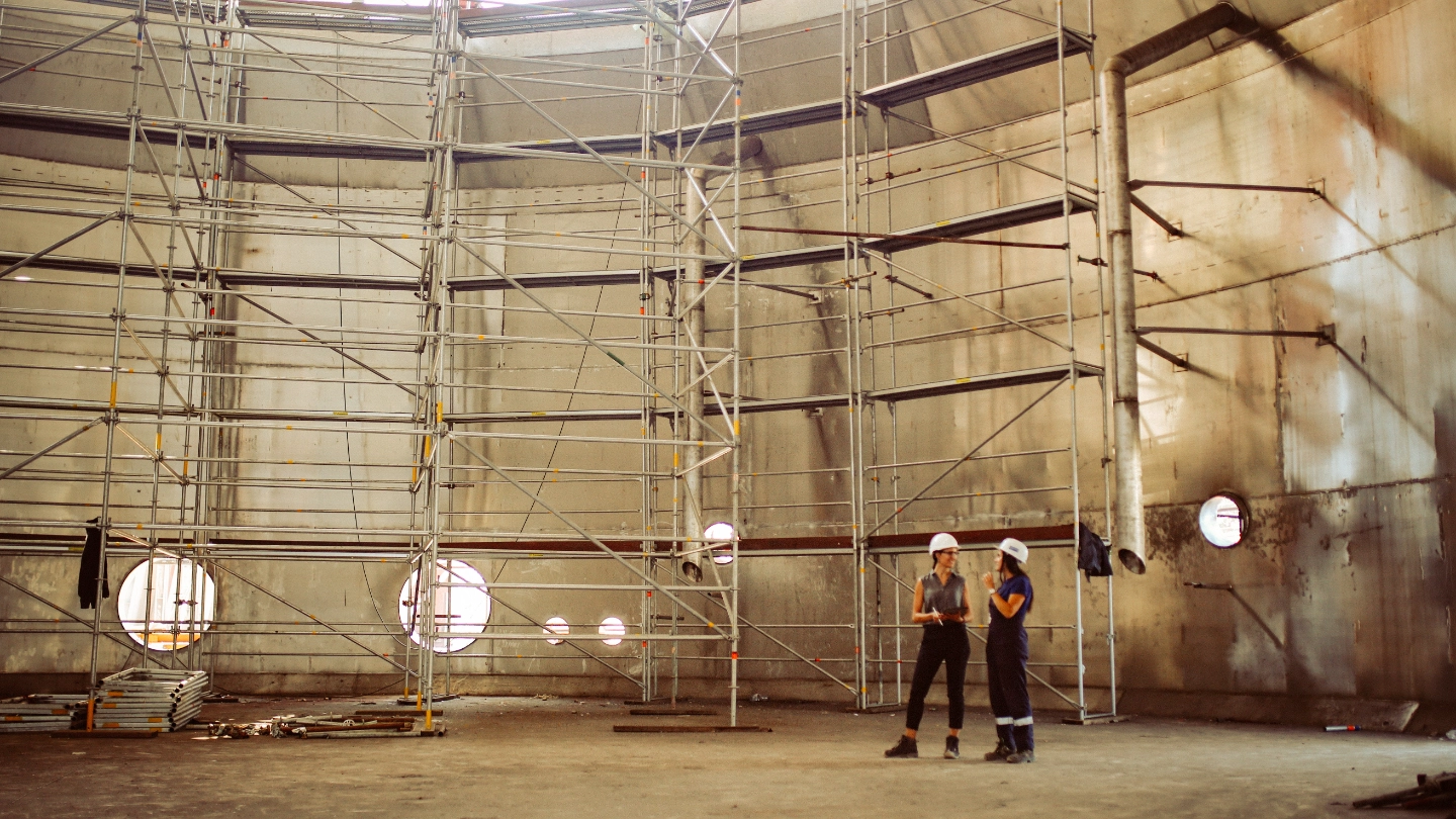 Two female construction workers talking image