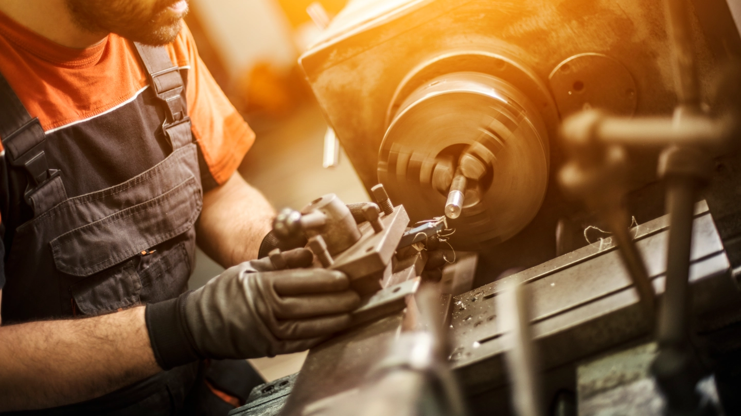 Male engineer drilling machine parts image