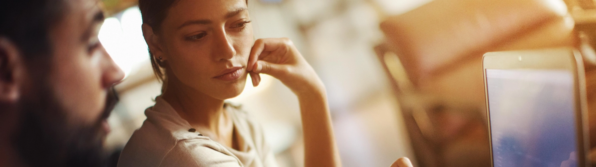 woman and man looking at laptop