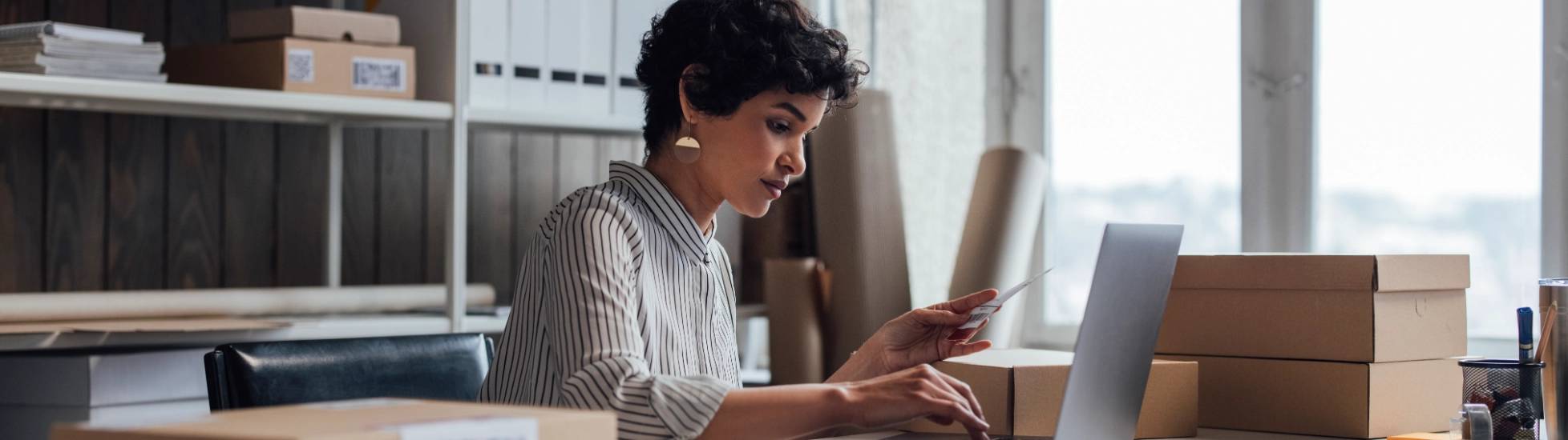 Mixed race woman in an office surrounded by boxes