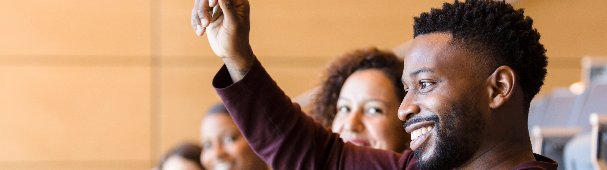 Man raising his hand to ask a question