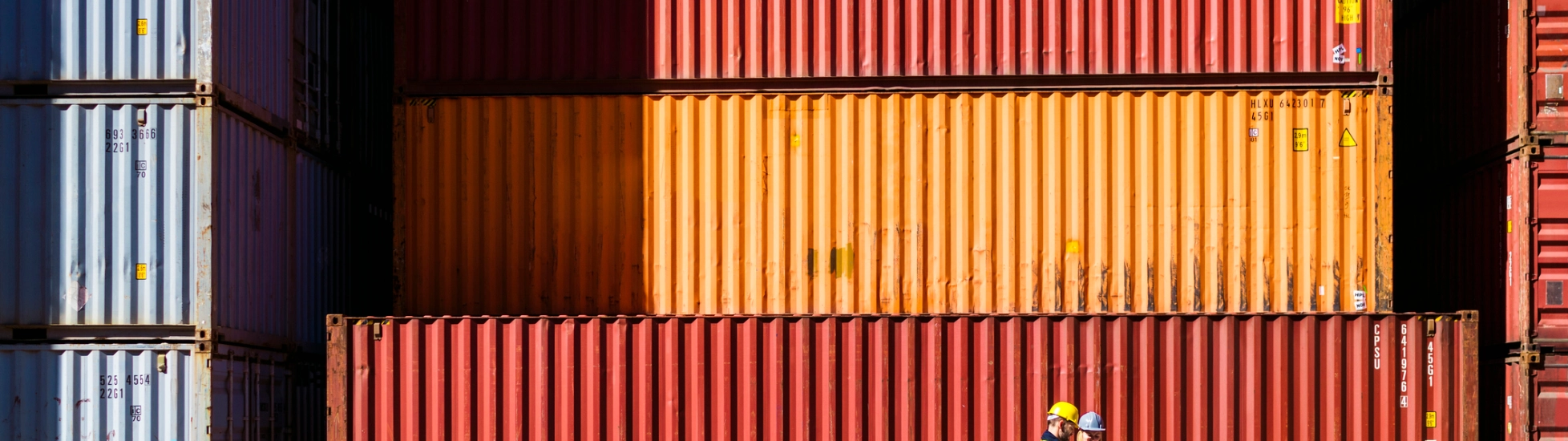 Two workers having a conversation about containers