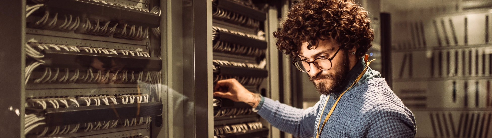 bearded male worker in mainframe room