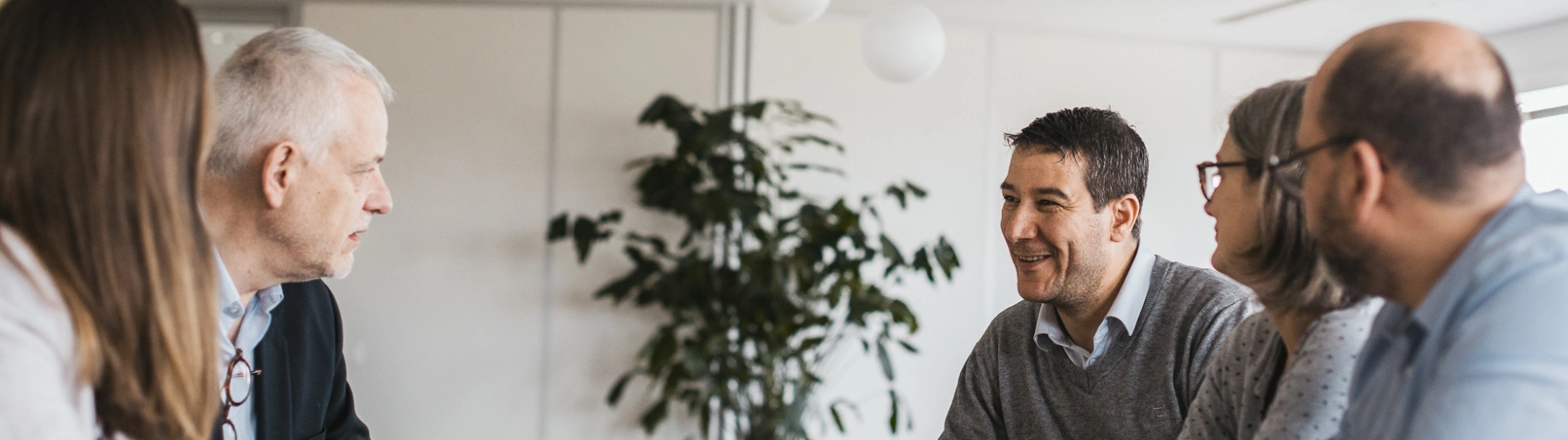 5 people having a conversation at a table
